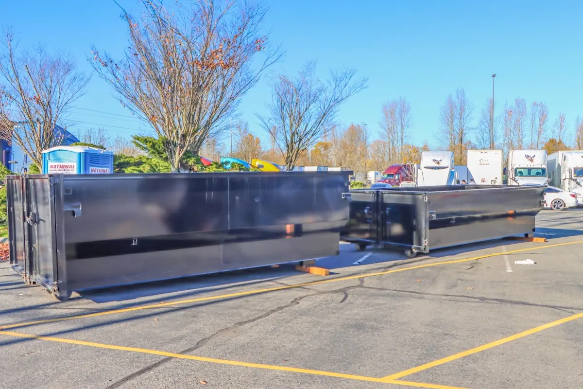 Professional dumpster rental service with roll-off container on residential driveway in Whitney